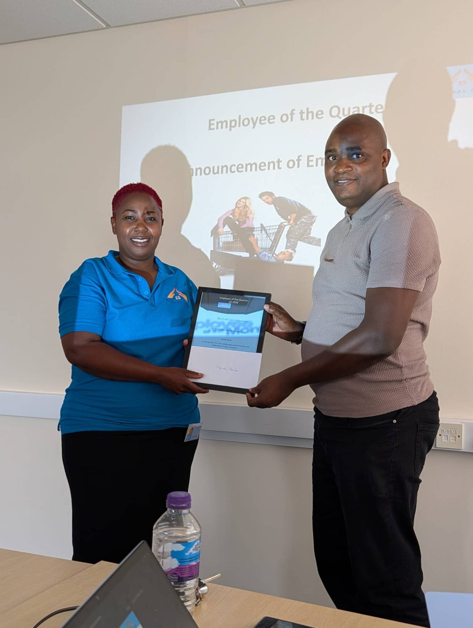 Judith receiving her Employee of the Quarter certificate